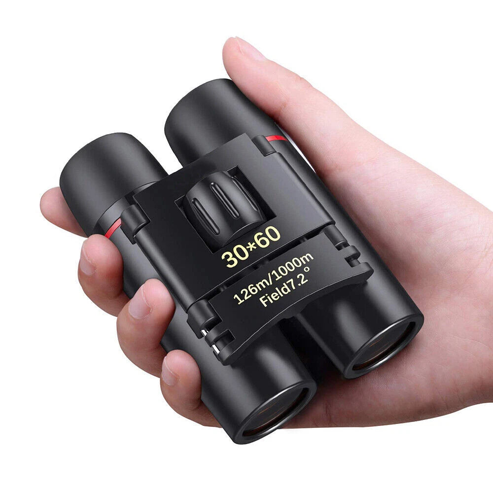 Black binoculars held in a hand against a white background
