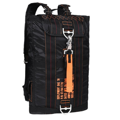 Black backpack with orange accents and a deployment bag tag on a white background