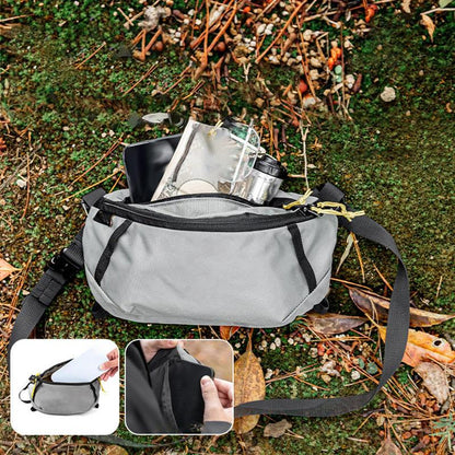Gray waist bag with black straps on a natural background