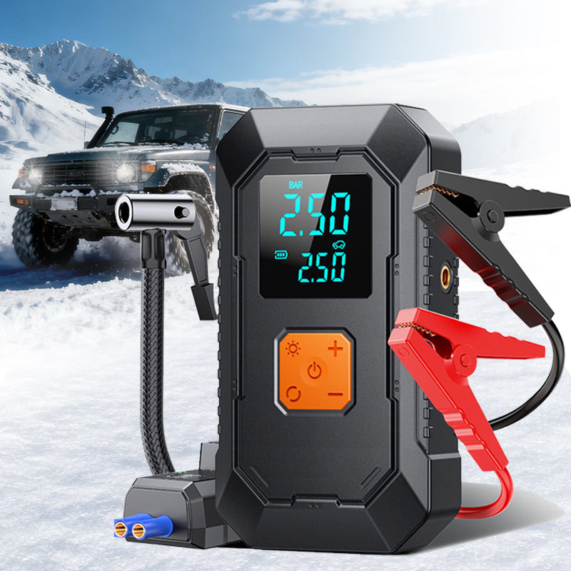 Car jump starter with digital display in a snowy landscape with a vehicle.