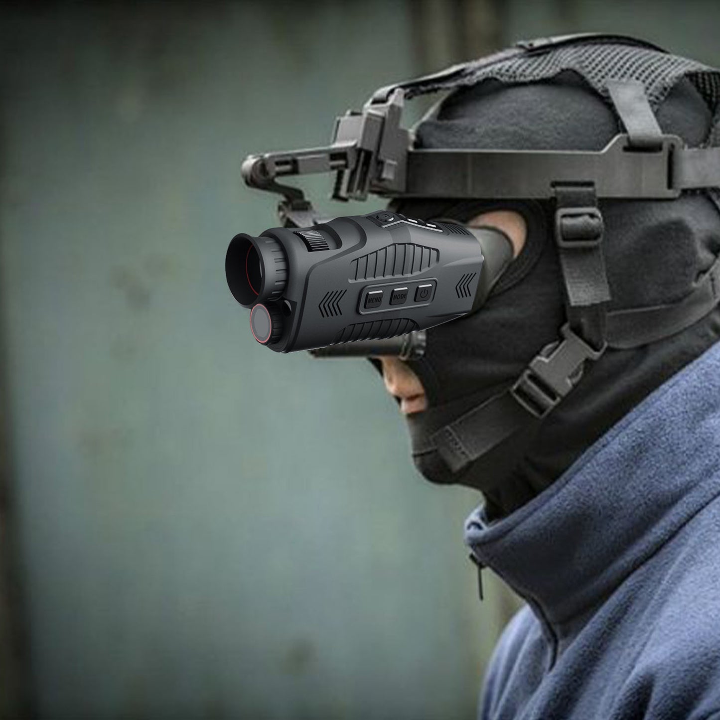 Person wearing a helmet with a night vision device against a blurred background