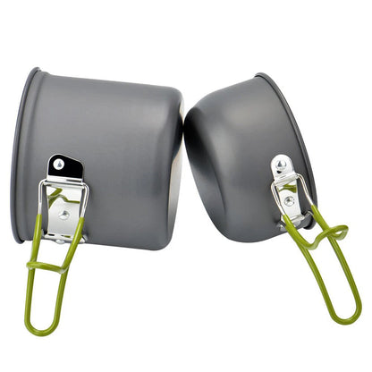 Two gray metal pots with green handles on a white background
