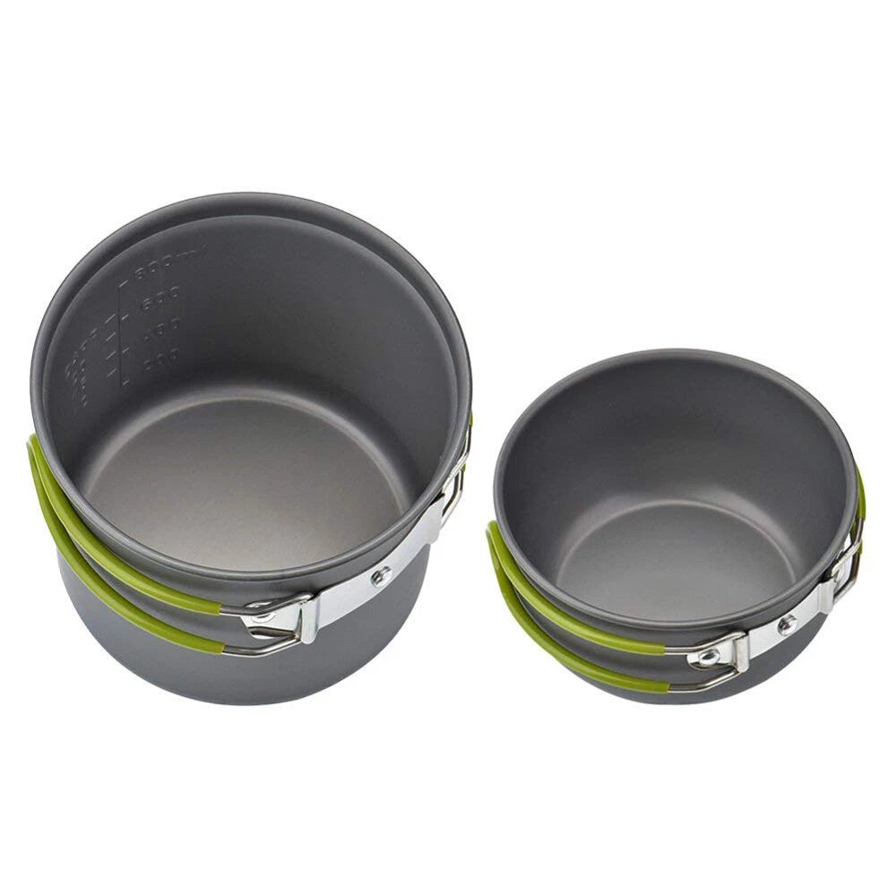 Two gray camping pots with green handles on a white background