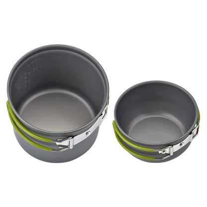 Two gray camping pots with green handles on a white background