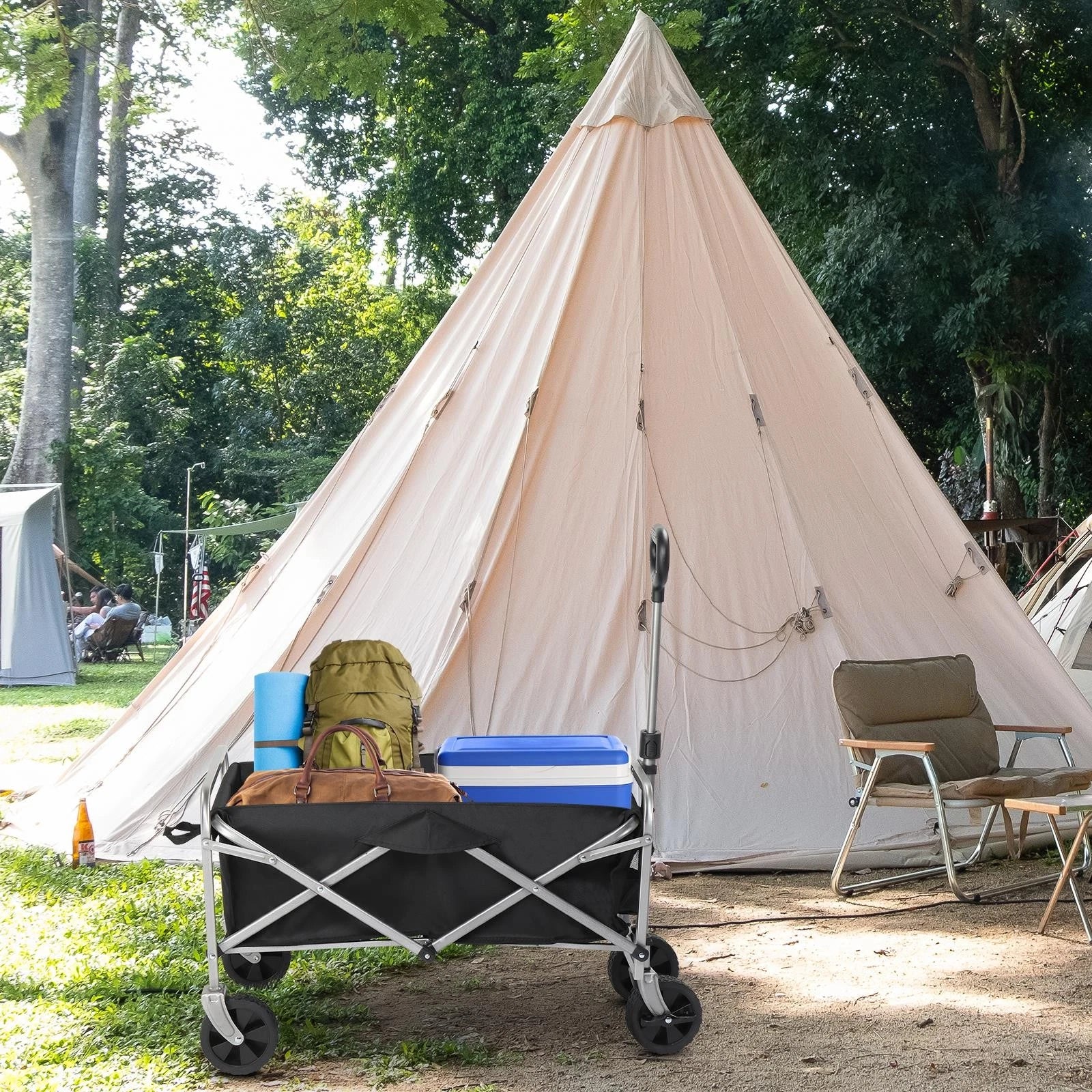 Beige teepee tent with camping furniture and equipment in a natural setting